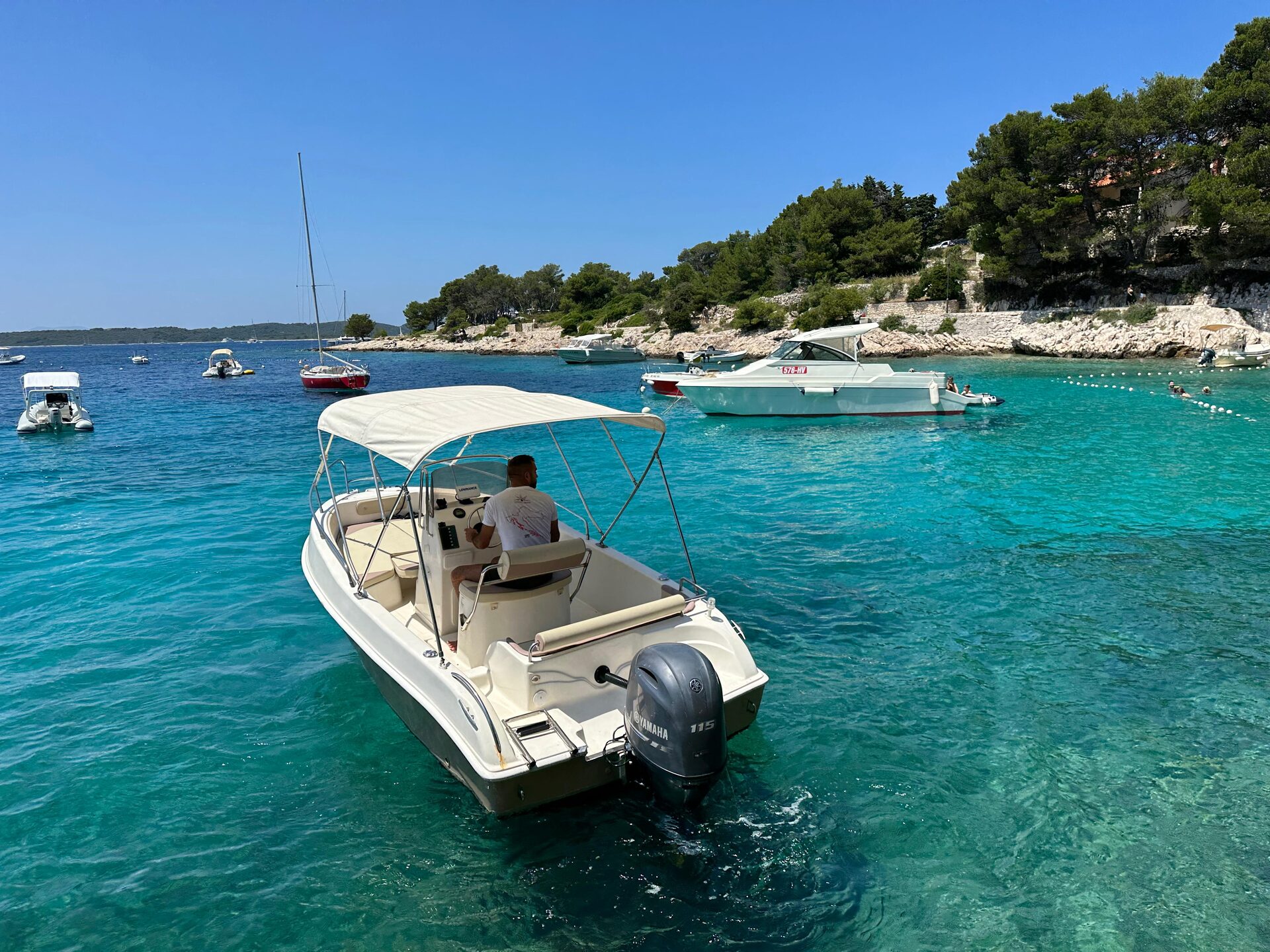 Blumax Bluline 19 open motorboat with bimini on clear Adriatic sea near the coast